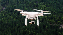 Drones article picture of a drone over a forest