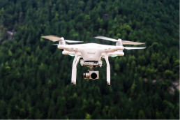 Drones article picture of a drone over a forest