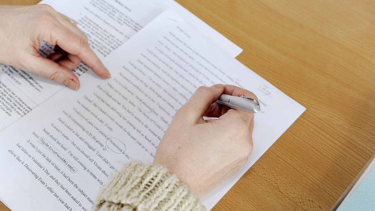 Image for choosing editing services article. A woman editing a document.