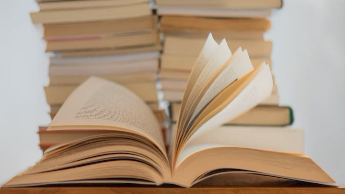 One book in front of a stack of books to highlight the importance of reading