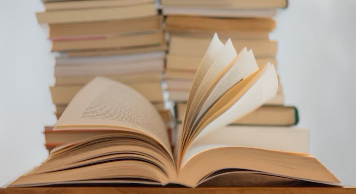 One book in front of a stack of books to highlight the importance of reading