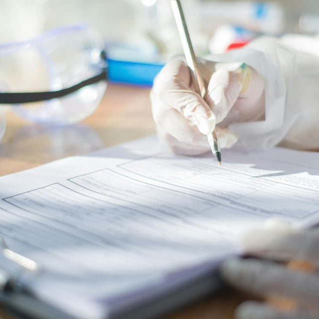 A person writing modal verbs during a scientific study.