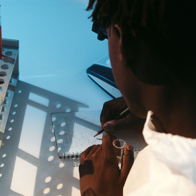 A scientists writing whislt conducting an experiment.