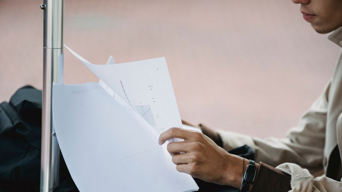 A man checking his research paper.