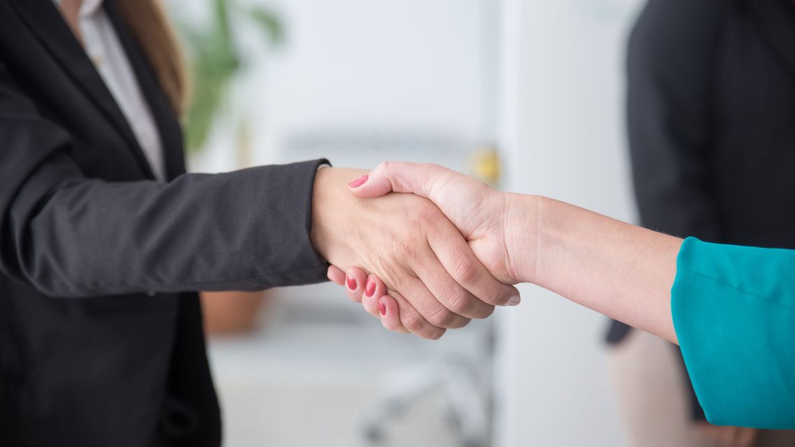 Two people shaking hands.