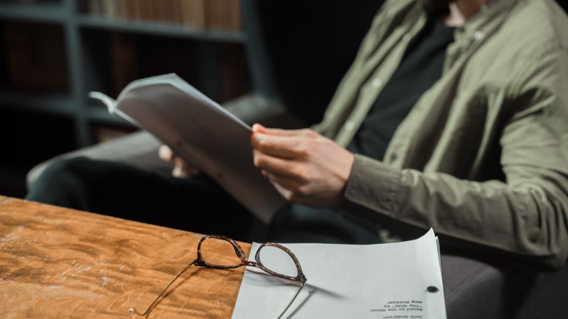 A man reading a research paper.